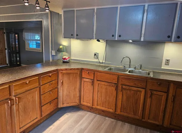 a kitchen with stainless steel appliances granite countertop wooden cabinets a sink and dishwasher