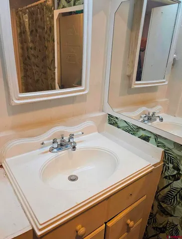 a bathroom with a sink and a mirror