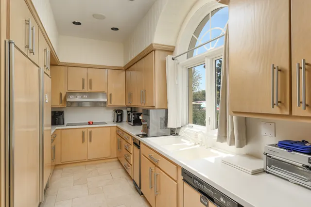 a spacious bedroom with a bed and a large window
