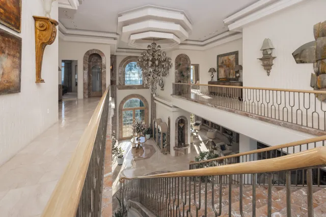 a bathroom with a granite countertop sink and a washing machine