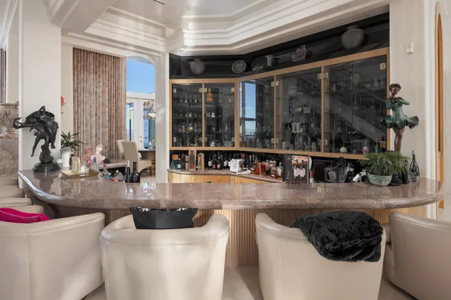 a living room with furniture a chandelier and a chandelier