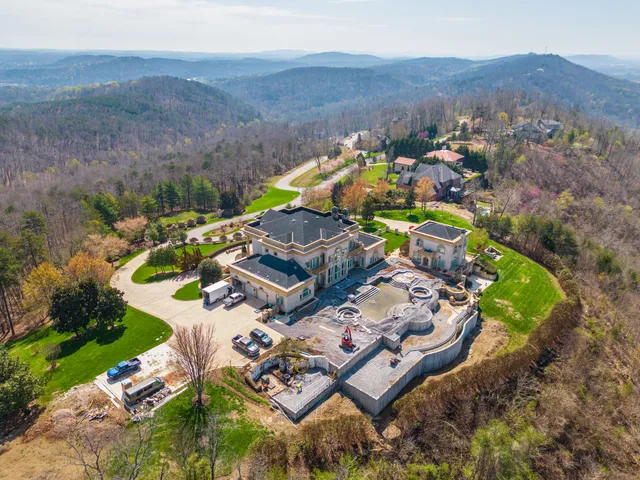 an aerial view of a house with garden space and ocean view
