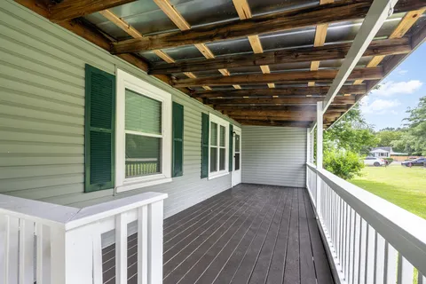 a view of porch with wooden floor