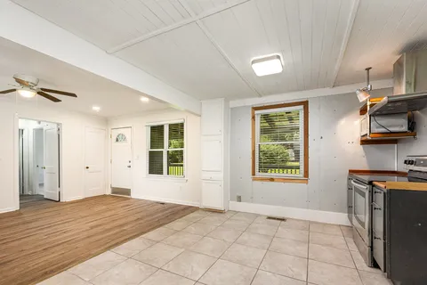 a view of a kitchen with a sink windows and a kitchen view