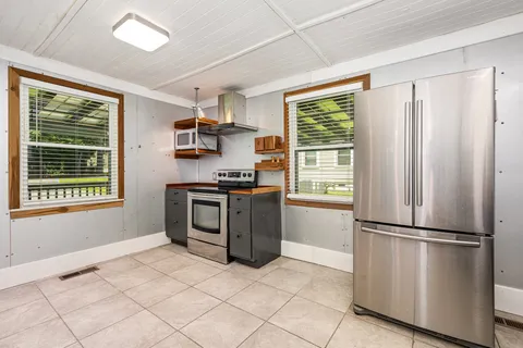 a kitchen with stainless steel appliances a refrigerator sink and stove