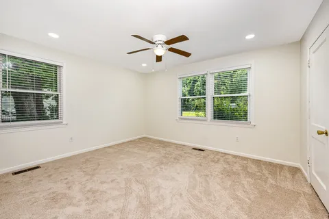 a view of empty room with ceiling fan