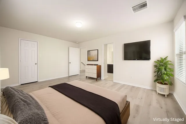 a bedroom with a bed and a flat screen tv