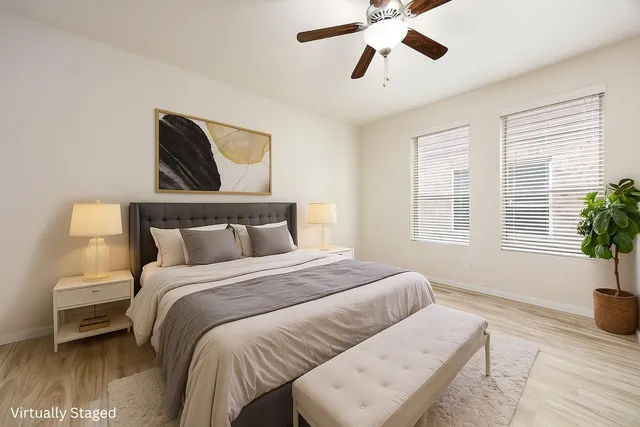 a bedroom with a bed and wooden floor