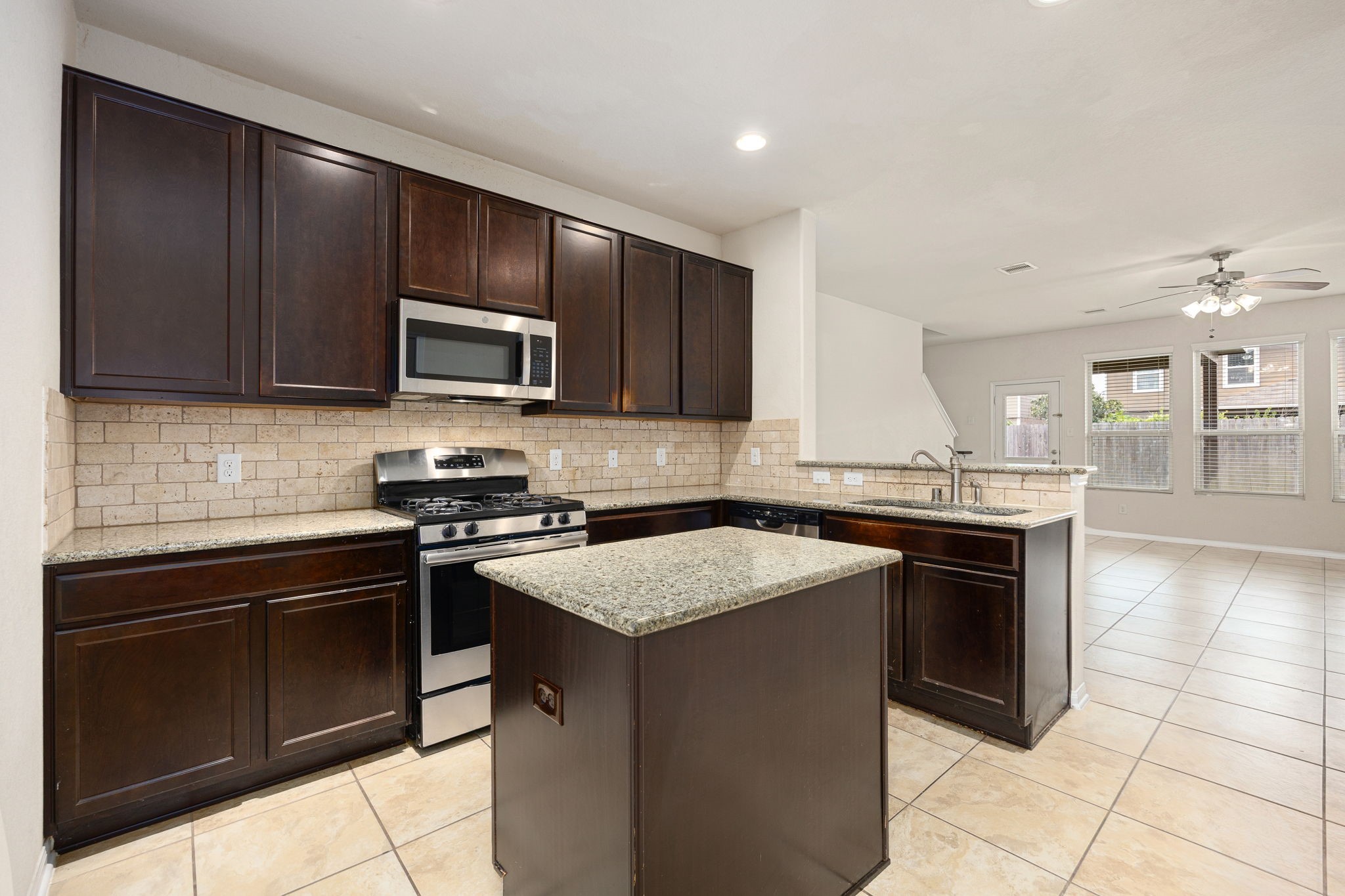 29322 Indian Clearing Spring, TX 77386 - Photo 19 of 41 a kitchen with a sink stove and microwave