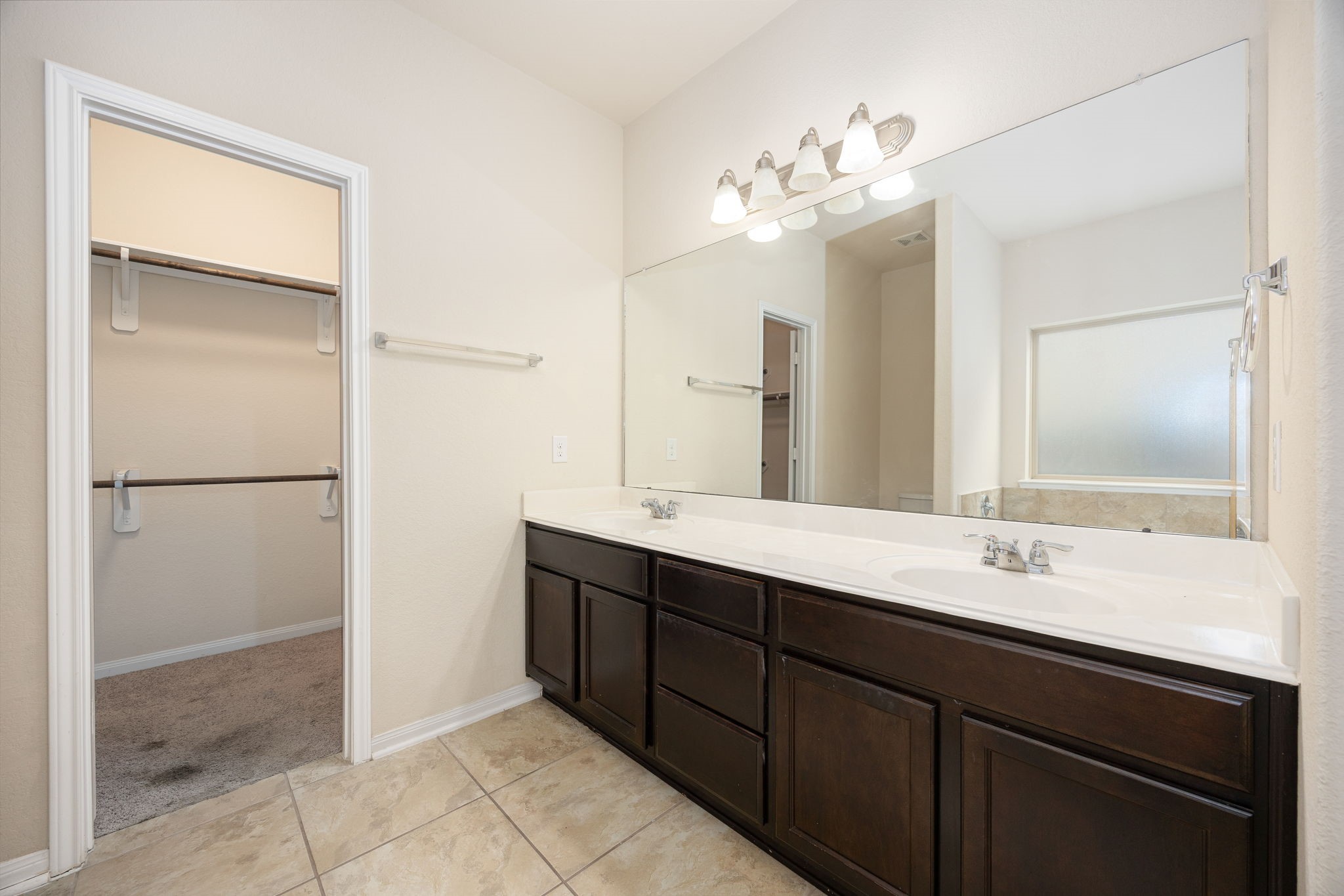 29322 Indian Clearing Spring, TX 77386 - Photo 27 of 41 a bathroom with a double vanity sink and a mirror