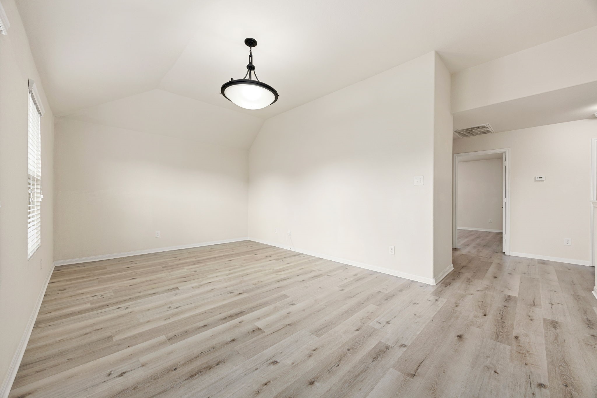 29322 Indian Clearing Spring, TX 77386 - Photo 31 of 41 a view of an empty room with wooden floor and a window