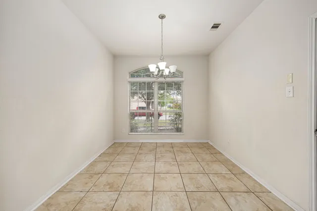 a view of an empty room with windows