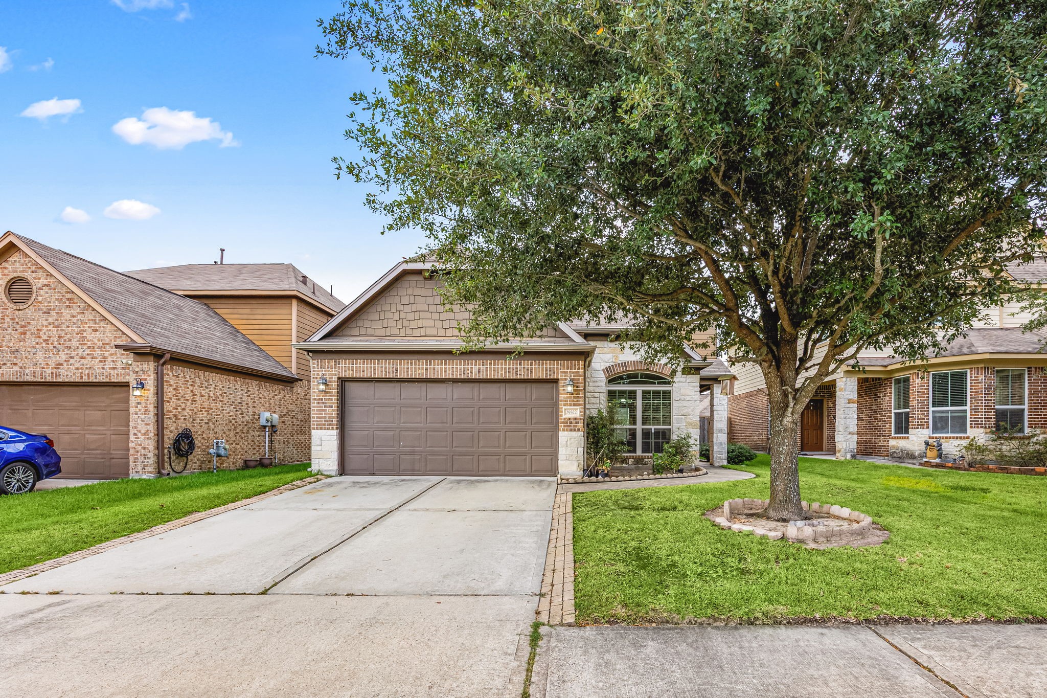 29322 Indian Clearing Spring, TX 77386 - Photo 4 of 41 a front view of a house with a garden and trees