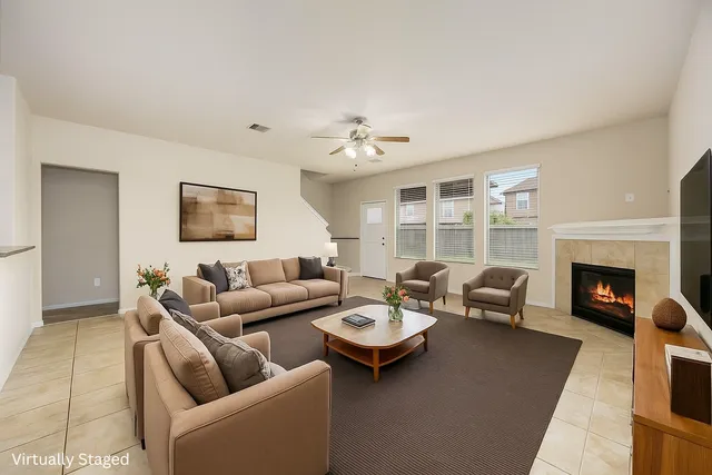 a living room with furniture a fireplace and a flat screen tv