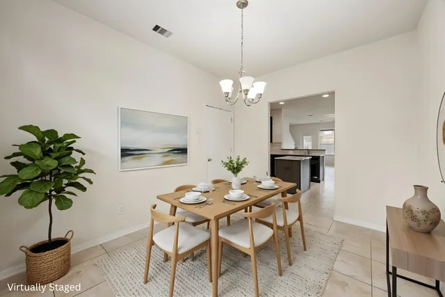 a dining room with furniture a chandelier and window