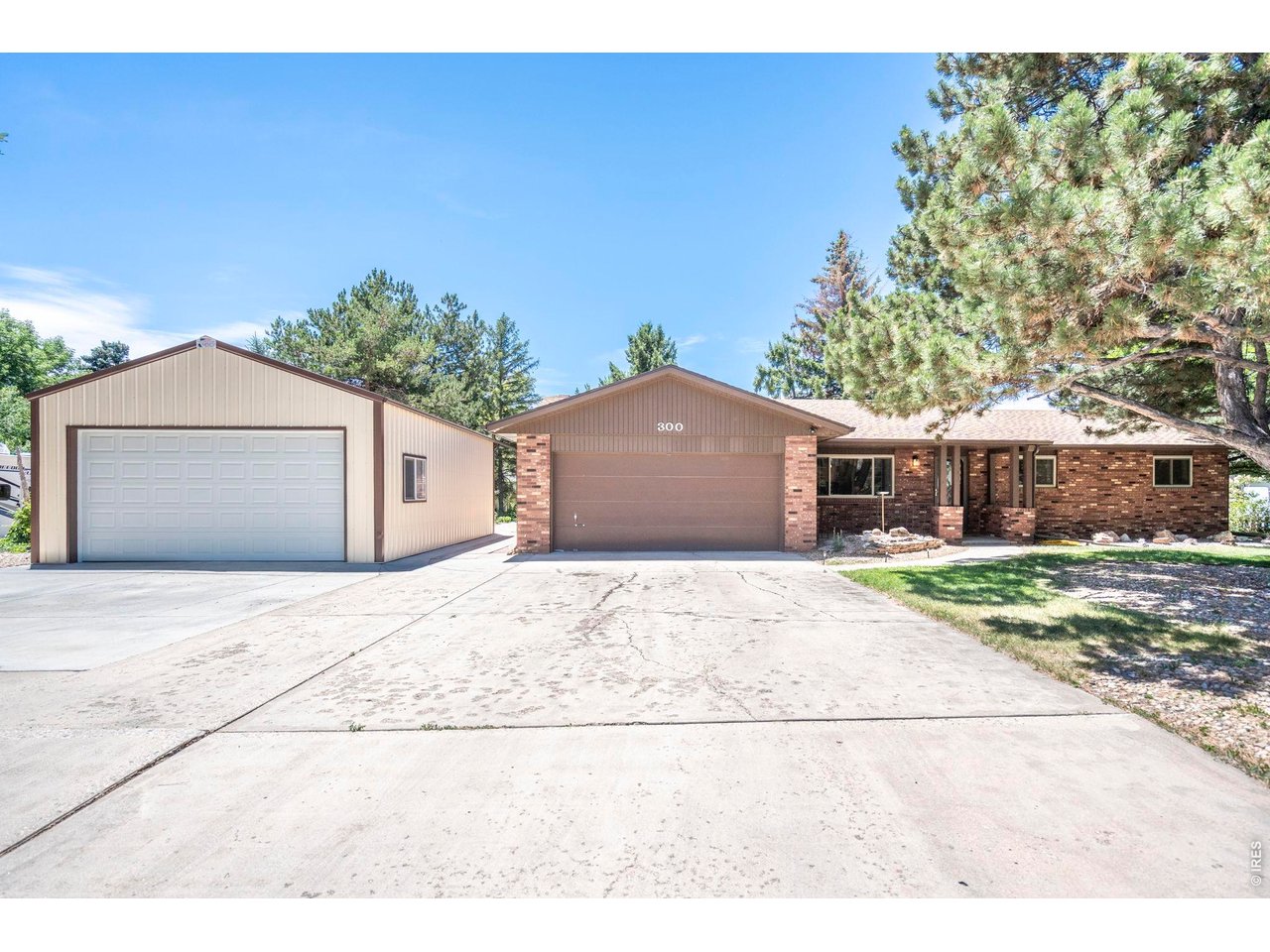 300 Ranch Acres Drive Loveland, CO 80538 - Photo 2 of 38 a front view of a house with a yard and garage
