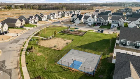 an aerial view of a house with outdoor seating