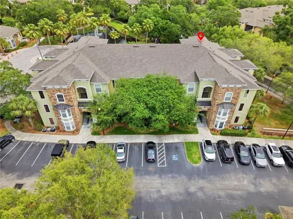 an aerial view of a house with a yard
