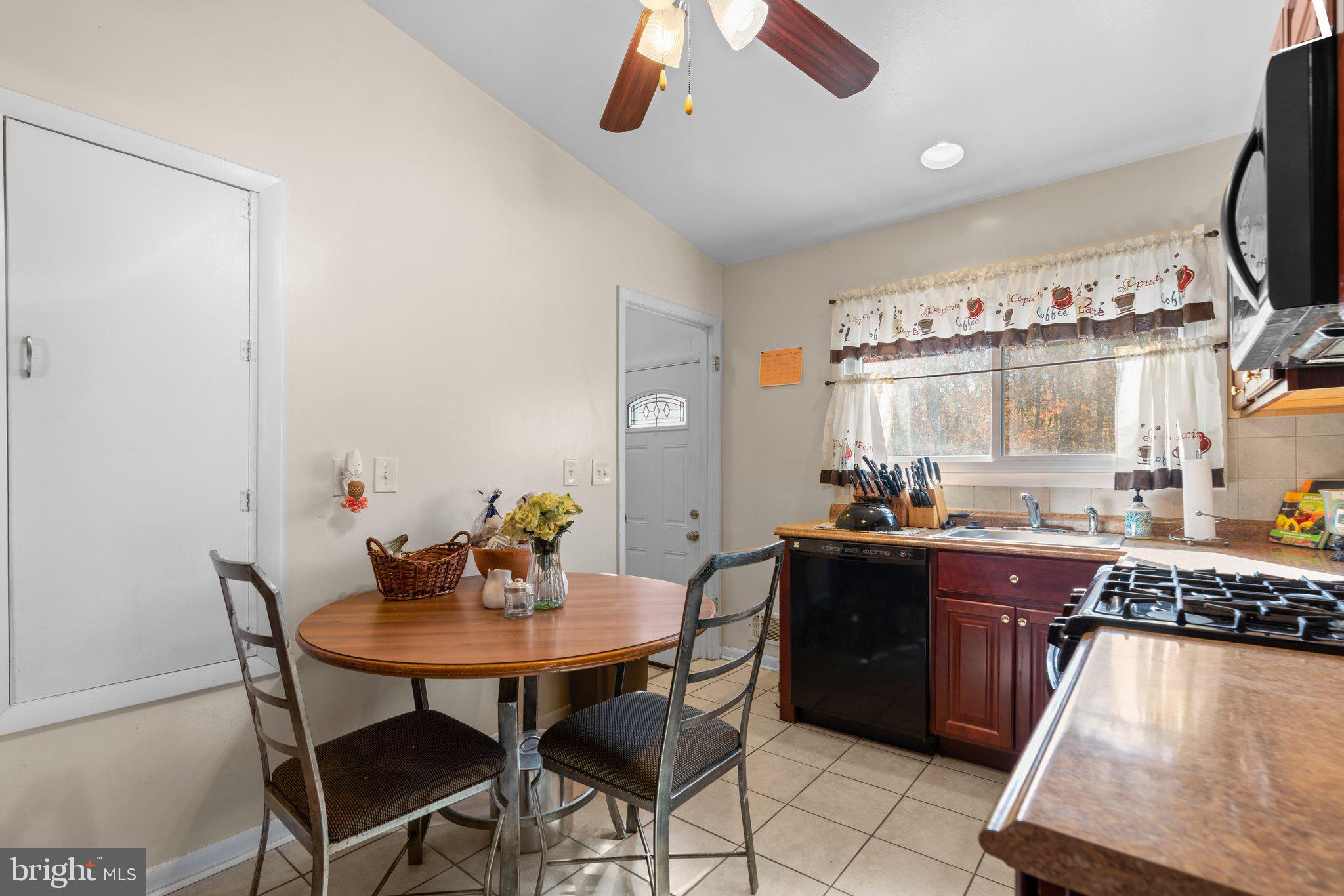 4727 Byron Road Windsor Mill, MD 21244 - Photo 12 of 35 a kitchen with a dining table and chairs