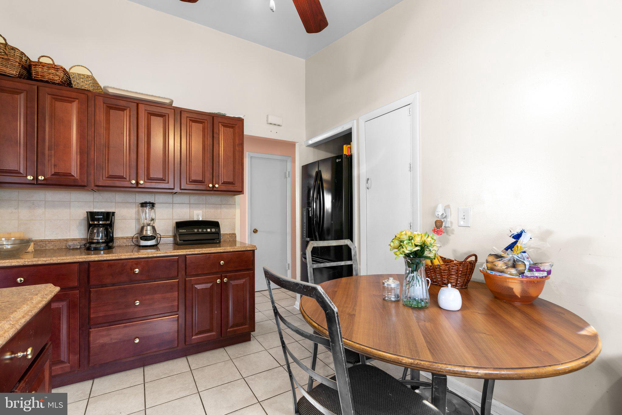 4727 Byron Road Windsor Mill, MD 21244 - Photo 15 of 35 a kitchen with stainless steel appliances granite countertop a sink a stove a dining table and chairs