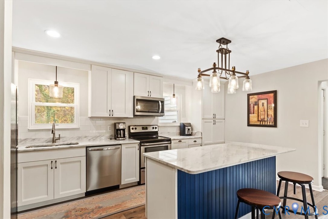 517 West Riverside Drive Lanexa, VA 23089 - Photo 2 of 27 a kitchen with a center island appliances and cabinets