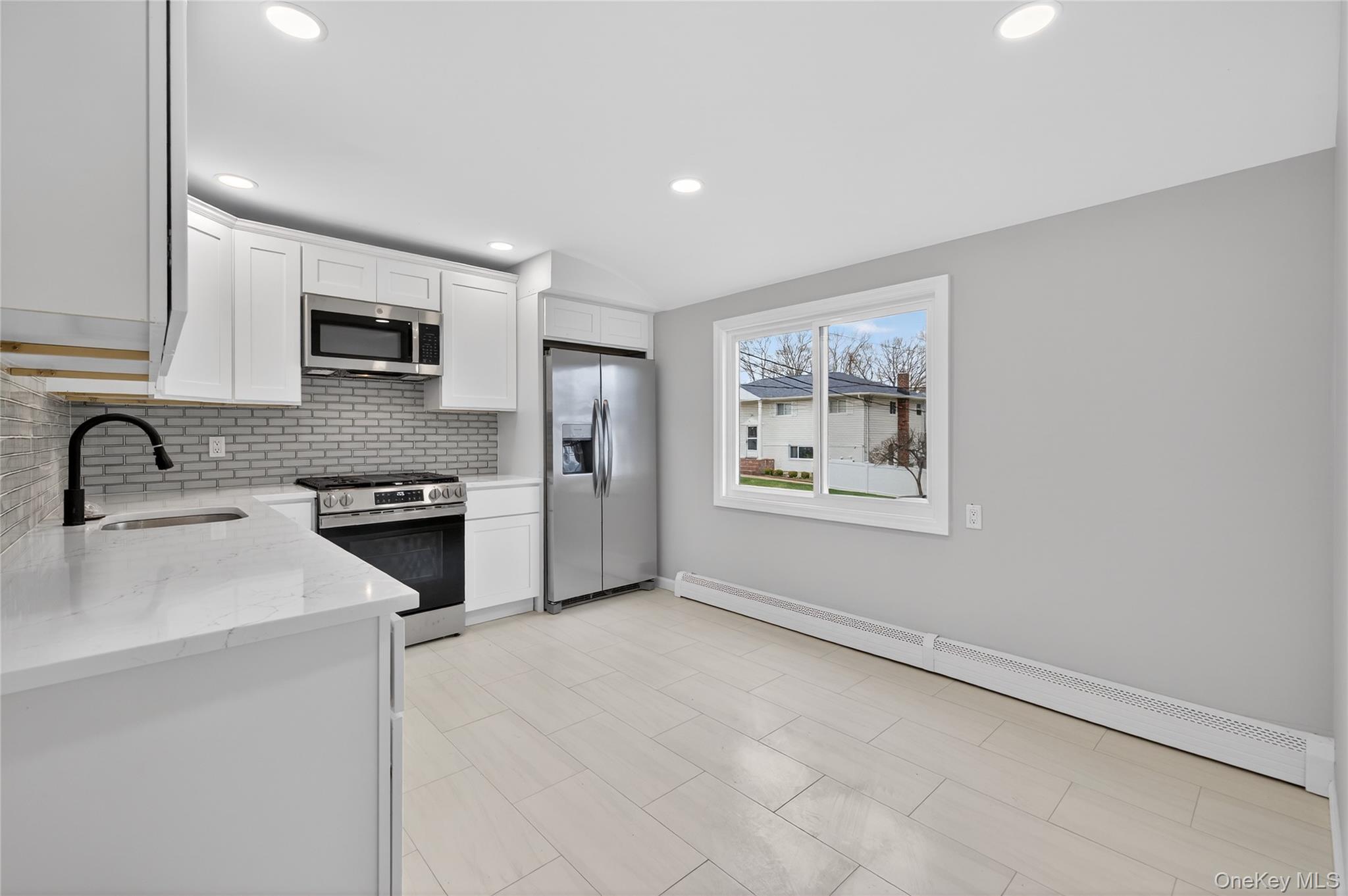 15 Lindsay Street Huntington, NY 11743 - Photo 8 of 23 a kitchen with stainless steel appliances granite countertop a refrigerator sink and stove