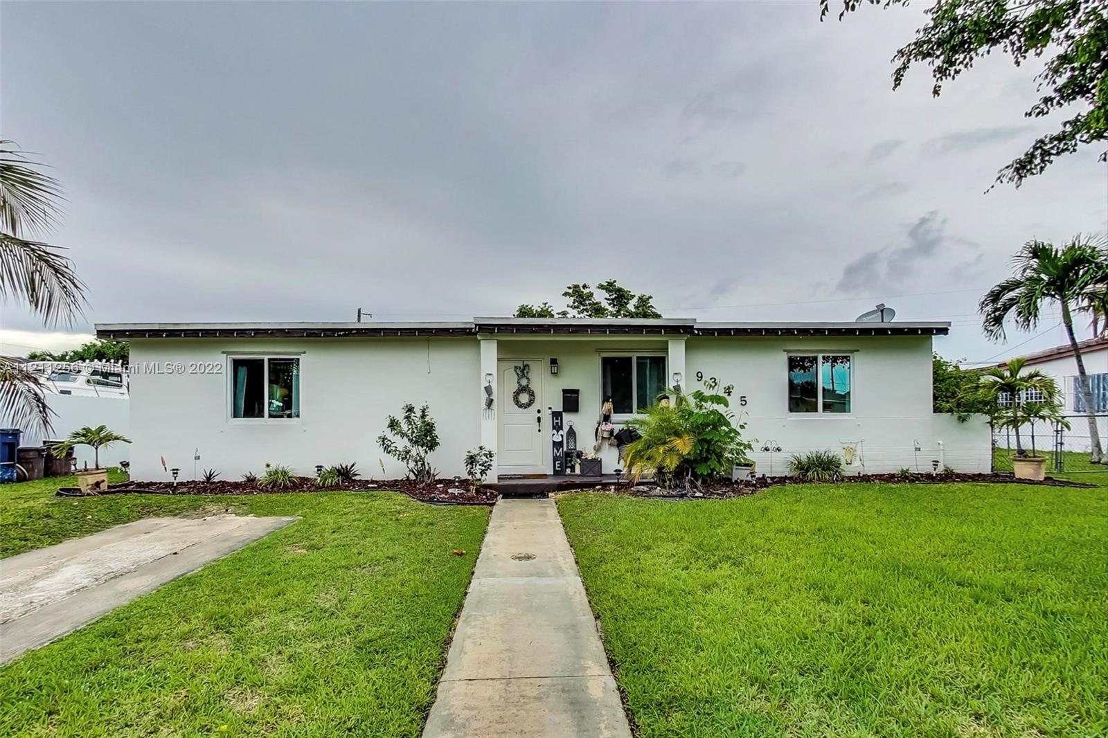 9345 Southwest 42nd Terrace Miami, FL 33165 - Photo 1 of 48 a front view of a house with a garden and plants
