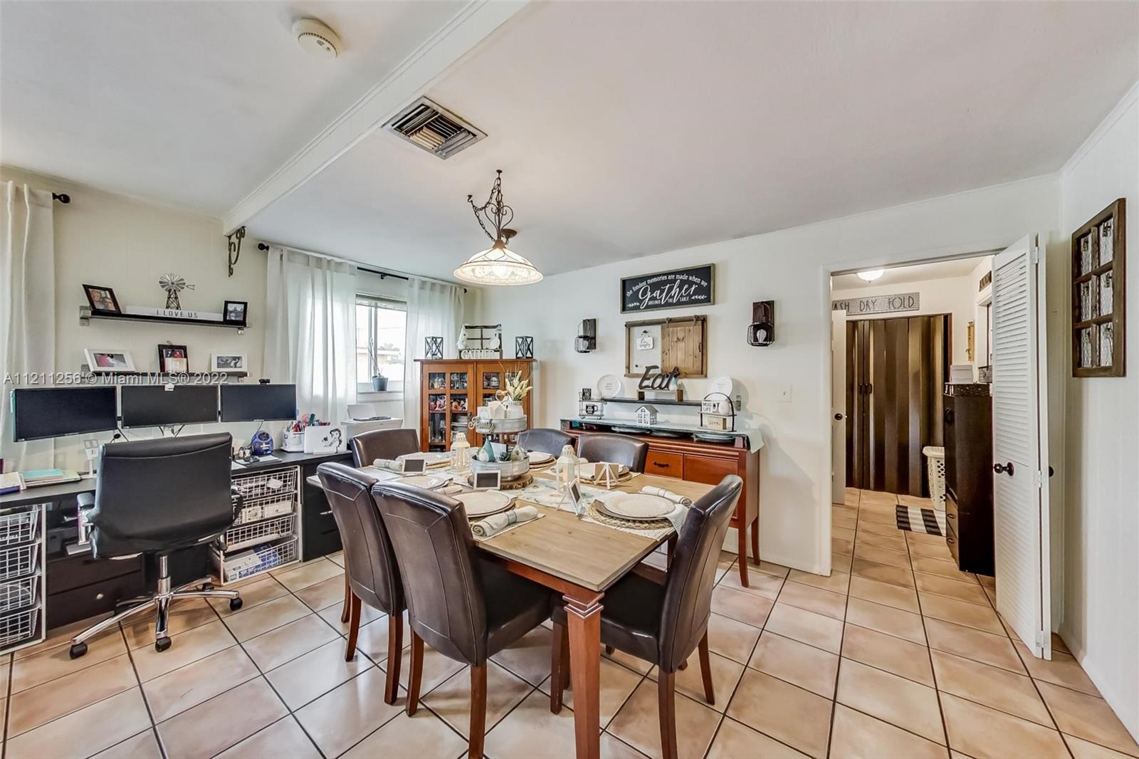 9345 Southwest 42nd Terrace Miami, FL 33165 - Photo 11 of 48 a dining room with stainless steel appliances kitchen island granite countertop a dining table and chairs