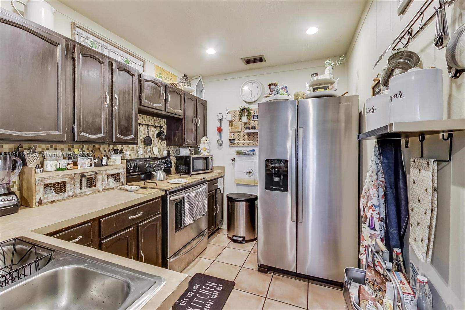 9345 Southwest 42nd Terrace Miami, FL 33165 - Photo 14 of 48 a kitchen with stainless steel appliances granite countertop a refrigerator a sink and dishwasher