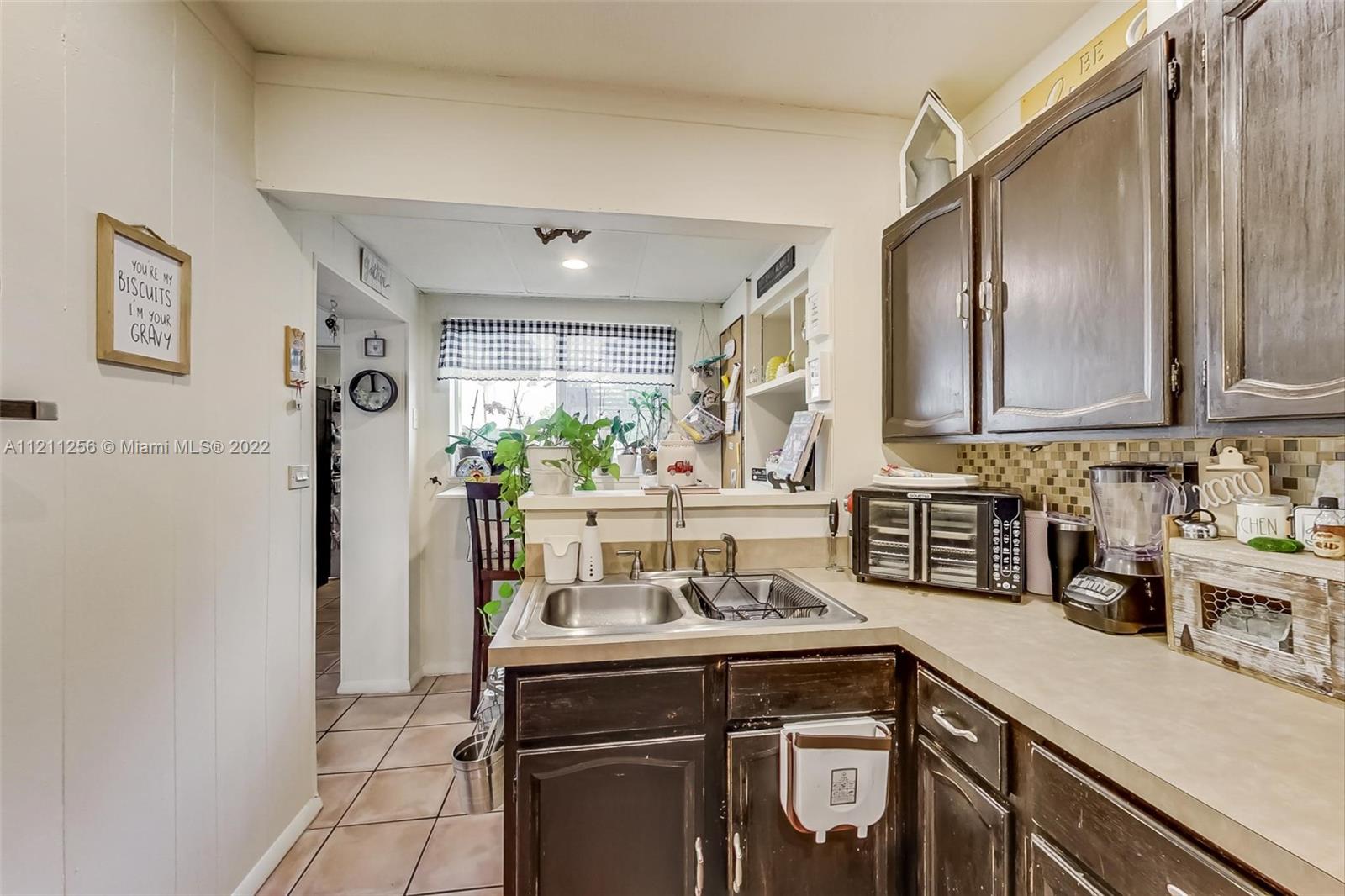 9345 Southwest 42nd Terrace Miami, FL 33165 - Photo 16 of 48 a kitchen with stainless steel appliances a sink a stove and a refrigerator