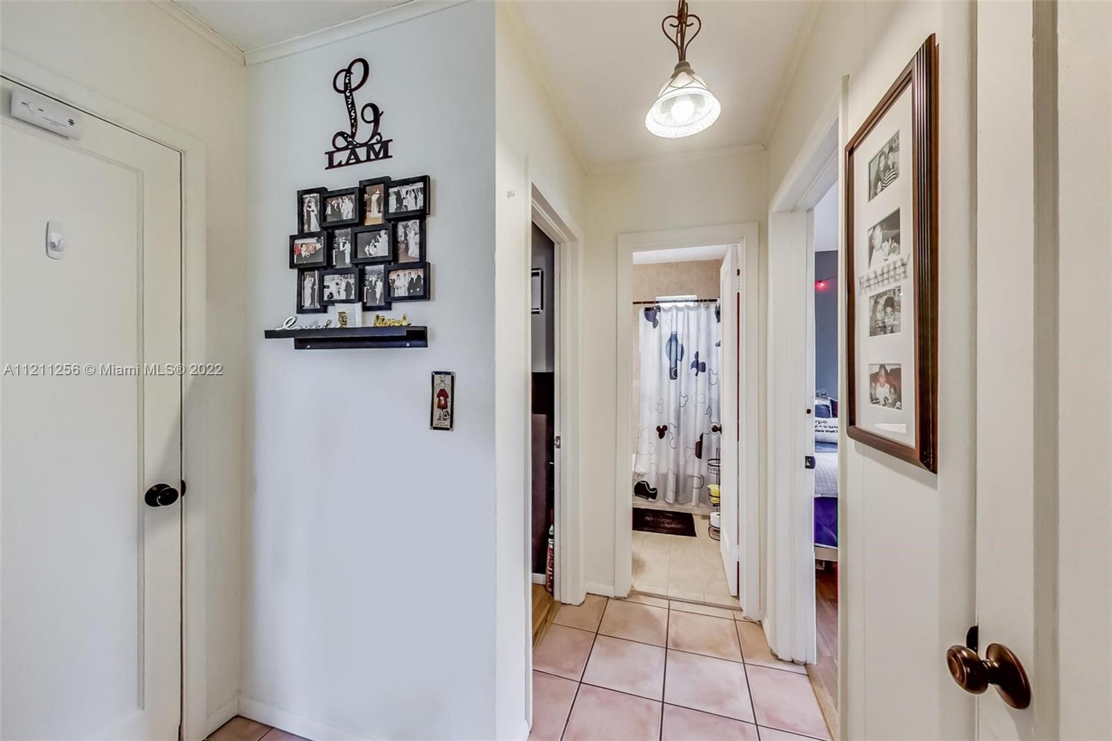 9345 Southwest 42nd Terrace Miami, FL 33165 - Photo 21 of 48 a view of a hallway with wooden floor and entryway