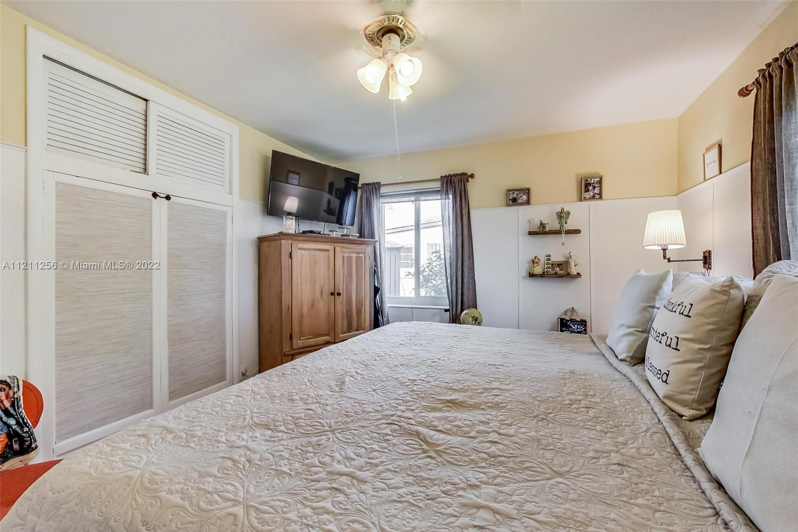 9345 Southwest 42nd Terrace Miami, FL 33165 - Photo 23 of 48 a bedroom with a bed and a television