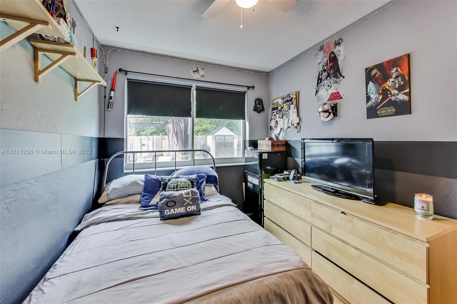 9345 Southwest 42nd Terrace Miami, FL 33165 - Photo 28 of 48 a bedroom with a bed a large window and flat screen tv