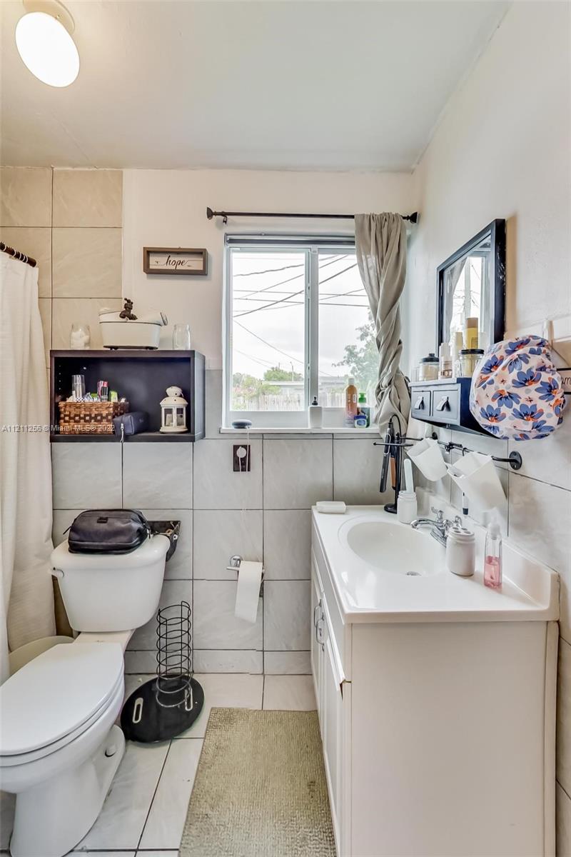 9345 Southwest 42nd Terrace Miami, FL 33165 - Photo 35 of 48 a bathroom with a sink toilet and mirror