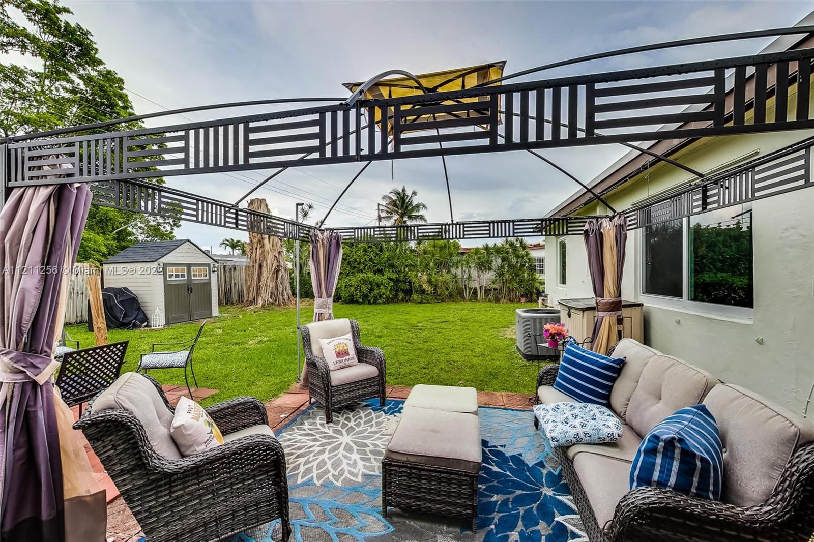 9345 Southwest 42nd Terrace Miami, FL 33165 - Photo 41 of 48 a view of a patio with couches chairs potted plants and a big yard