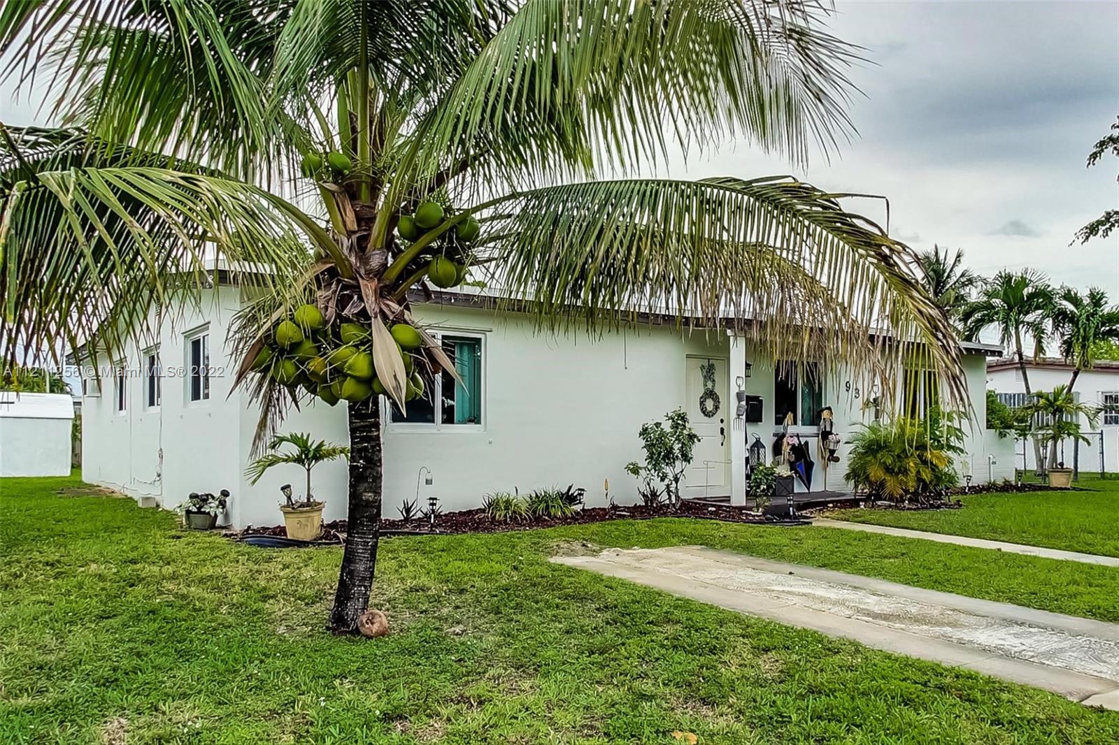 9345 Southwest 42nd Terrace Miami, FL 33165 - Photo 5 of 48 a backyard of a house with potted plants and palm trees