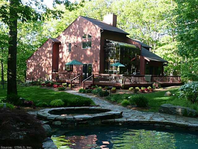 a view of a house with a yard and sitting area