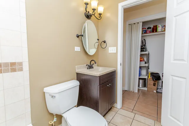 a bathroom with a toilet a sink and mirror