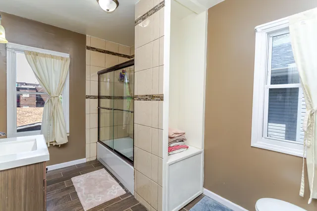 a bathroom with a glass shower door