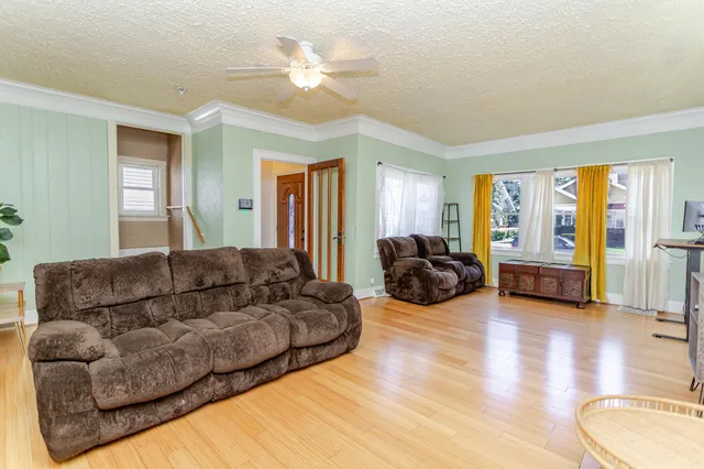 a living room with furniture ceiling and a window