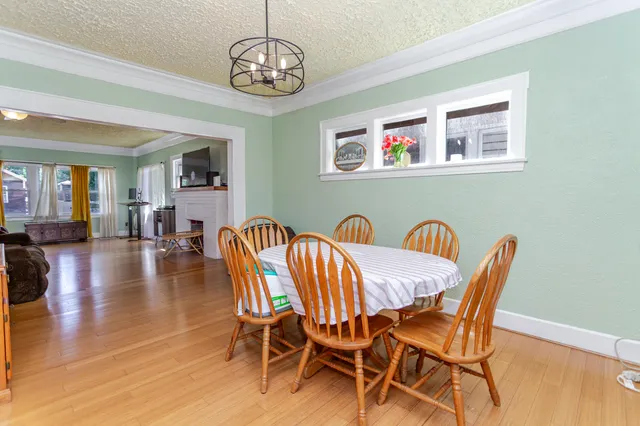 a view of a dining room with furniture wooden floor and chandelier
