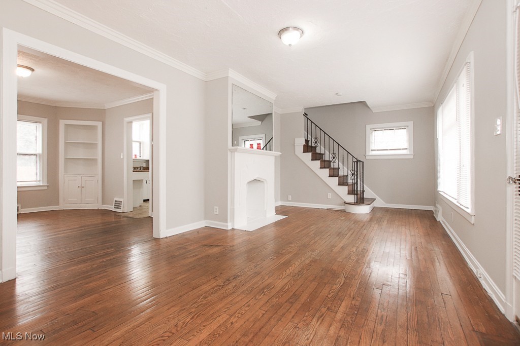 3973 Navahoe Road Cleveland, OH 44121 - Photo 3 of 14 Unfurnished living room featuring built in shelves, baseboards, and hardwood / wood-style flooring