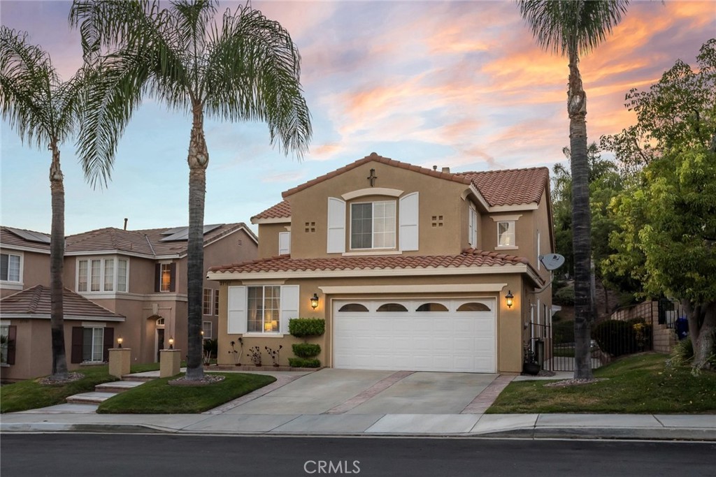 25707 Lewis Way Stevenson Ranch, CA 91381 - Photo 18 of 35 a front view of a house with a garden and a garage