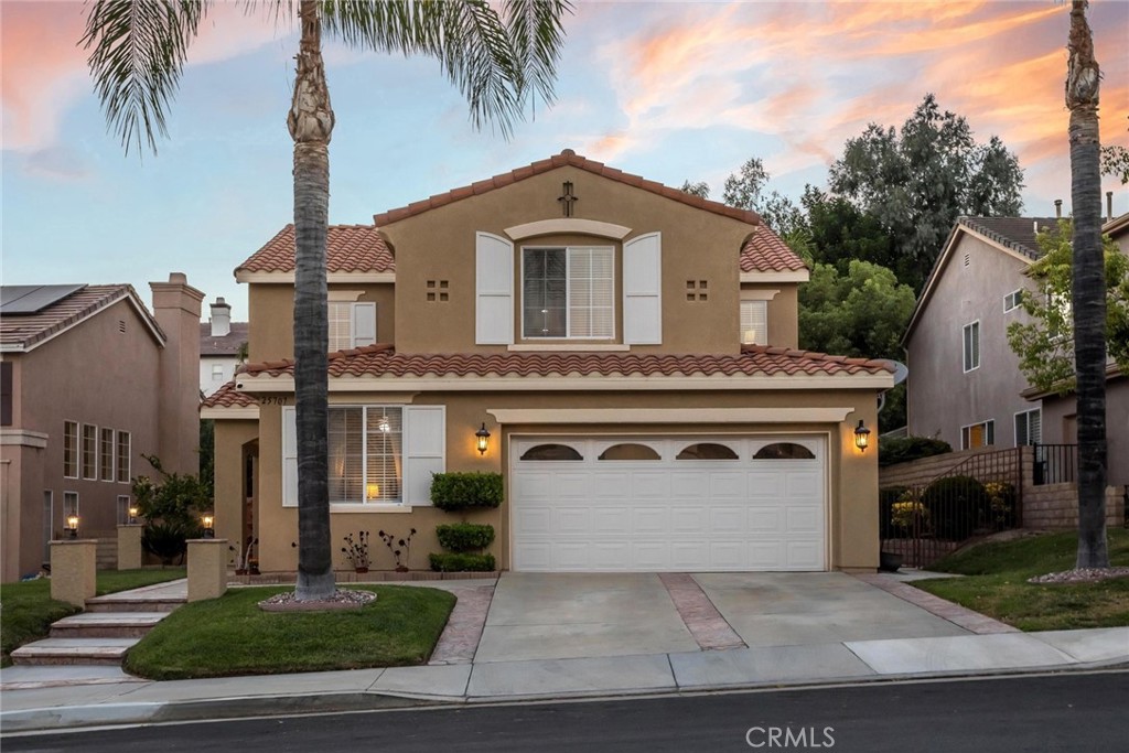 25707 Lewis Way Stevenson Ranch, CA 91381 - Photo 19 of 35 a view of a white house with a yard and potted plants