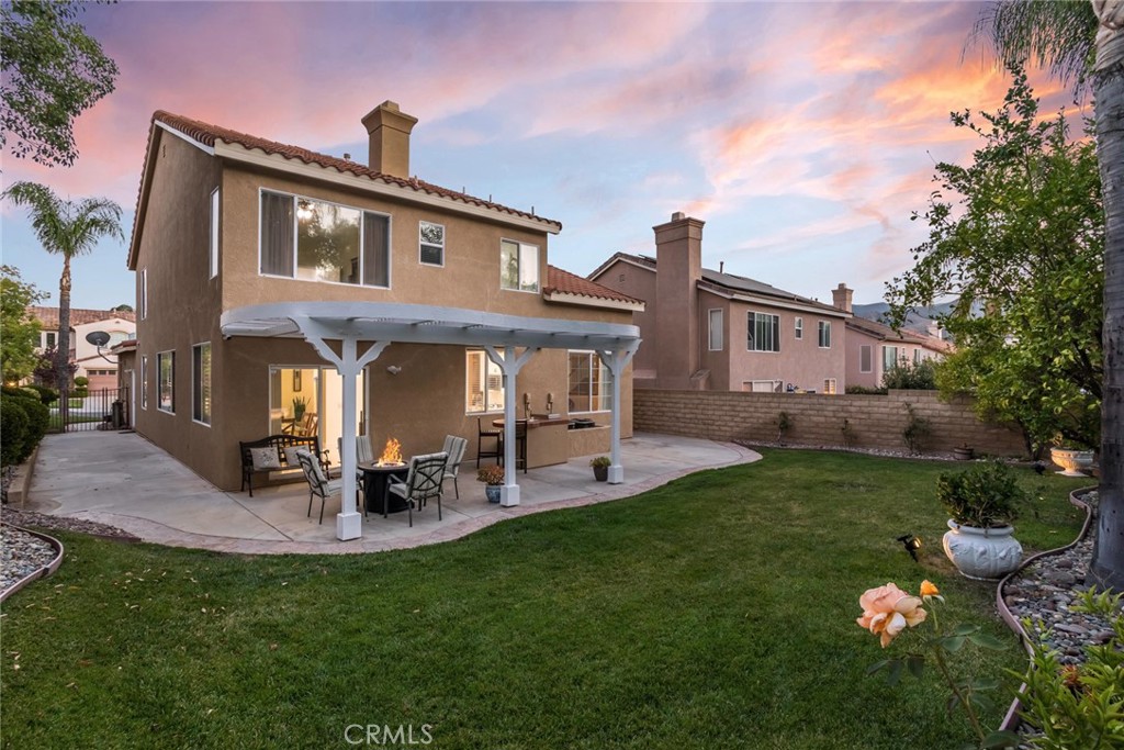 25707 Lewis Way Stevenson Ranch, CA 91381 - Photo 2 of 35 a front view of a house with a garden and patio