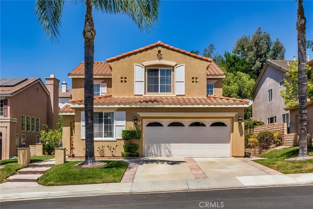 25707 Lewis Way Stevenson Ranch, CA 91381 - Photo 3 of 35 a front view of a house with a yard and garage