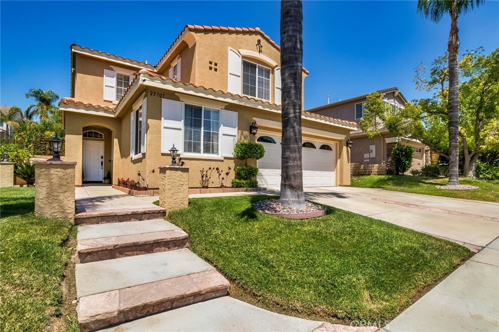 25707 Lewis Way Stevenson Ranch, CA 91381 - Photo 6 of 35 a front view of a house with a yard