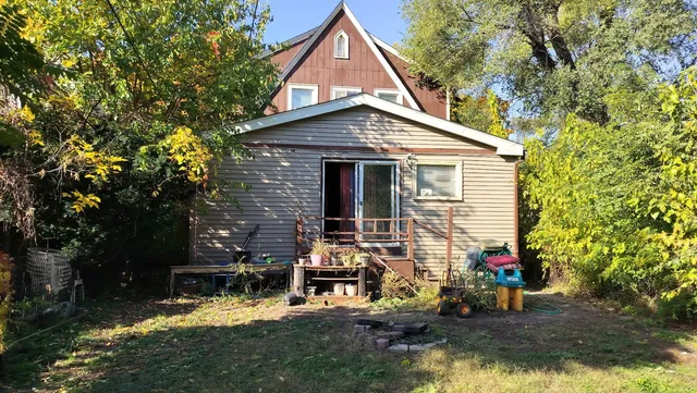 a view of house with backyard space and sitting area