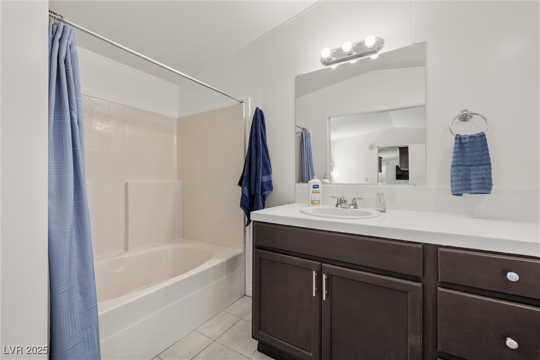 1771 East Brian Road Pahrump, NV 89048 - Photo 20 of 29 Full bathroom featuring tile patterned flooring, vanity, and shower / bath combination with curtain