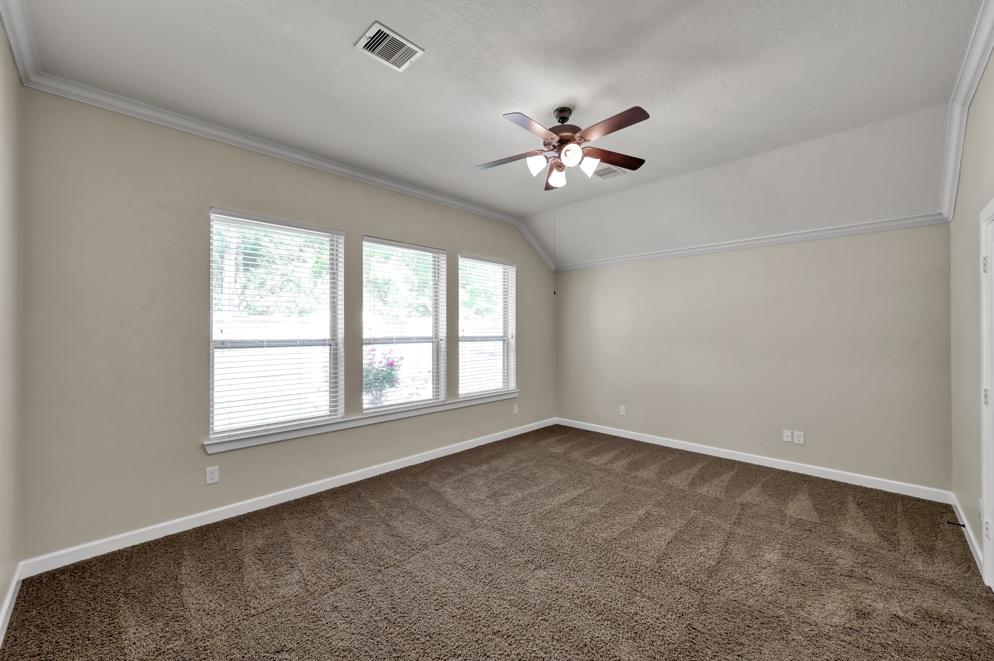 31507 Boulder Cliff Lane Spring, TX 77386 - Photo 25 of 45 This spacious room features neutral walls, a ceiling fan, and ample natural light from large windows, perfect for a cozy living area or bedroom.